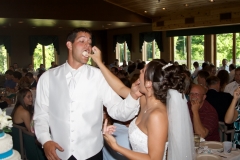Groom-Bride-Feeding-Cake-Reception