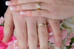 Groom-Bride-Hands-Rings-Flowers