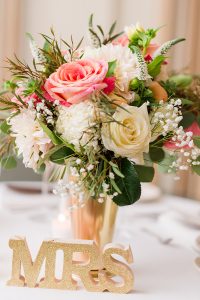 Wedding Reception Details. Bouquet of flowers on head table. MRS
